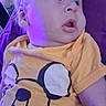 Simon is registered to the contest to win money with this photo: baby, child, yellow_shirt, adventure_time, purple_light, indoor, couch, clothing, face, portrait, toddler, curious, hair, chubby_cheeks, casual, seat, young_child, soft_light, expression, relaxing