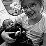 Soan participe au concours pour gagner de l'argent avec cette photo : child, baby, newborn, glasses, smiling, holding, indoor, hospital, bed, blanket, person, family, care, happy, young_girl, portrait, together, comfort, clothing, love