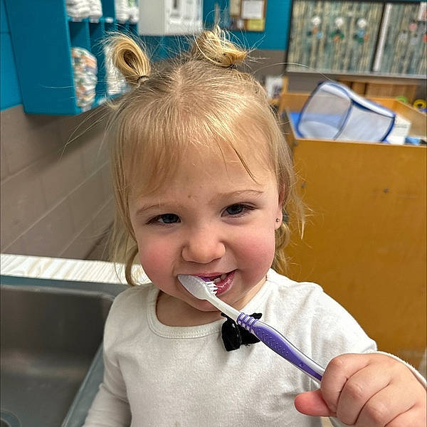 Scarlett is registered to the contest to win money with this photo: biting, child, cutlery, eyelash, fun, gesture, hairstyle, happy, joy, kitchen_utensil, office_supplies, person, photograph, photography, room, smile, snapshot, toddler, tooth