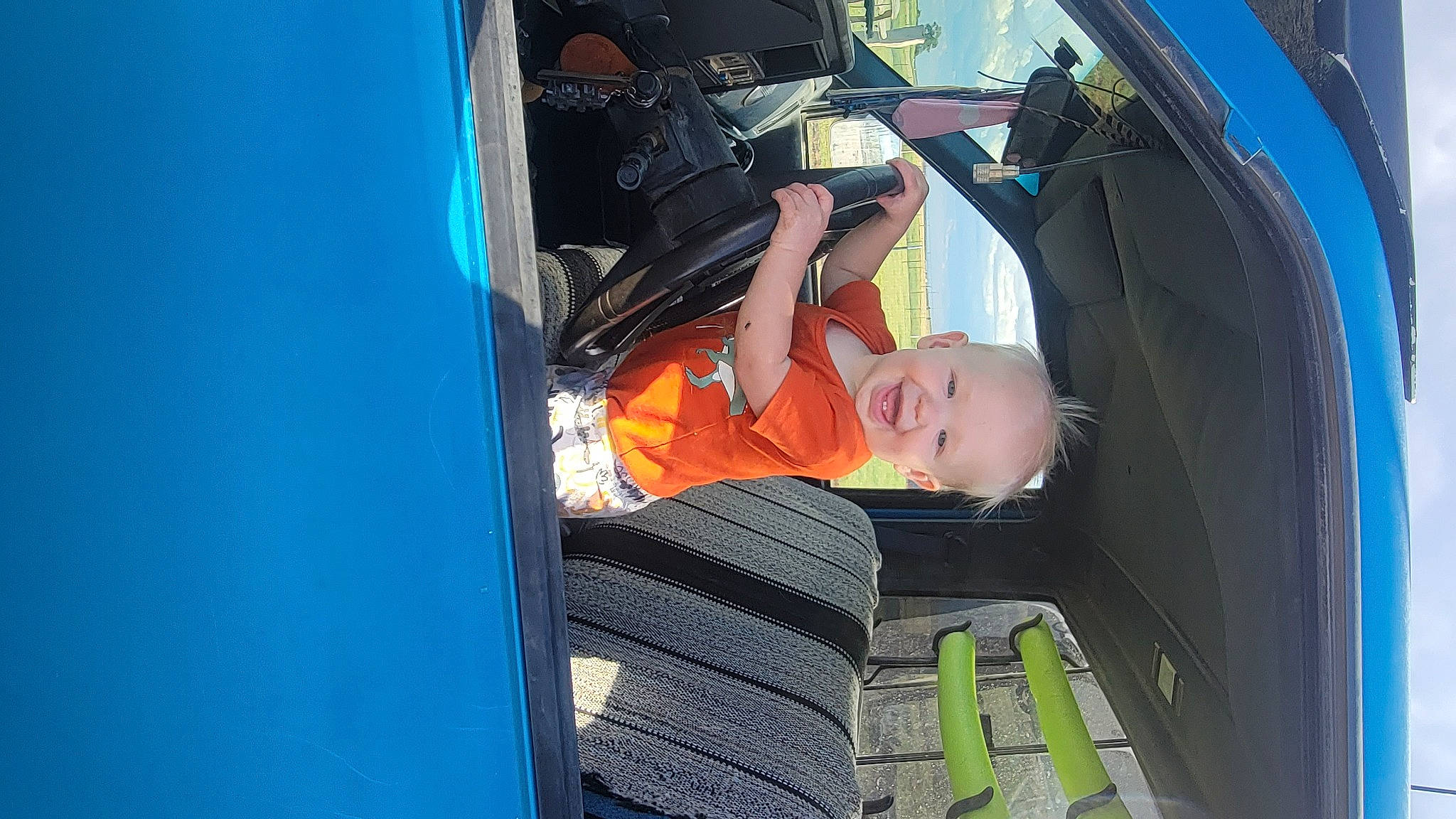 Ethan is registered to the contest to win money with this photo: auto_part, automotive_design, automotive_exterior, automotive_lighting, automotive_tire, automotive_wheel_system, automotive_window_part, bumper, electric_blue, fun, glass, hood, joy, leisure, mode_of_transport, motor_vehicle, person, tints_and_shades, toddler, vehicle_door