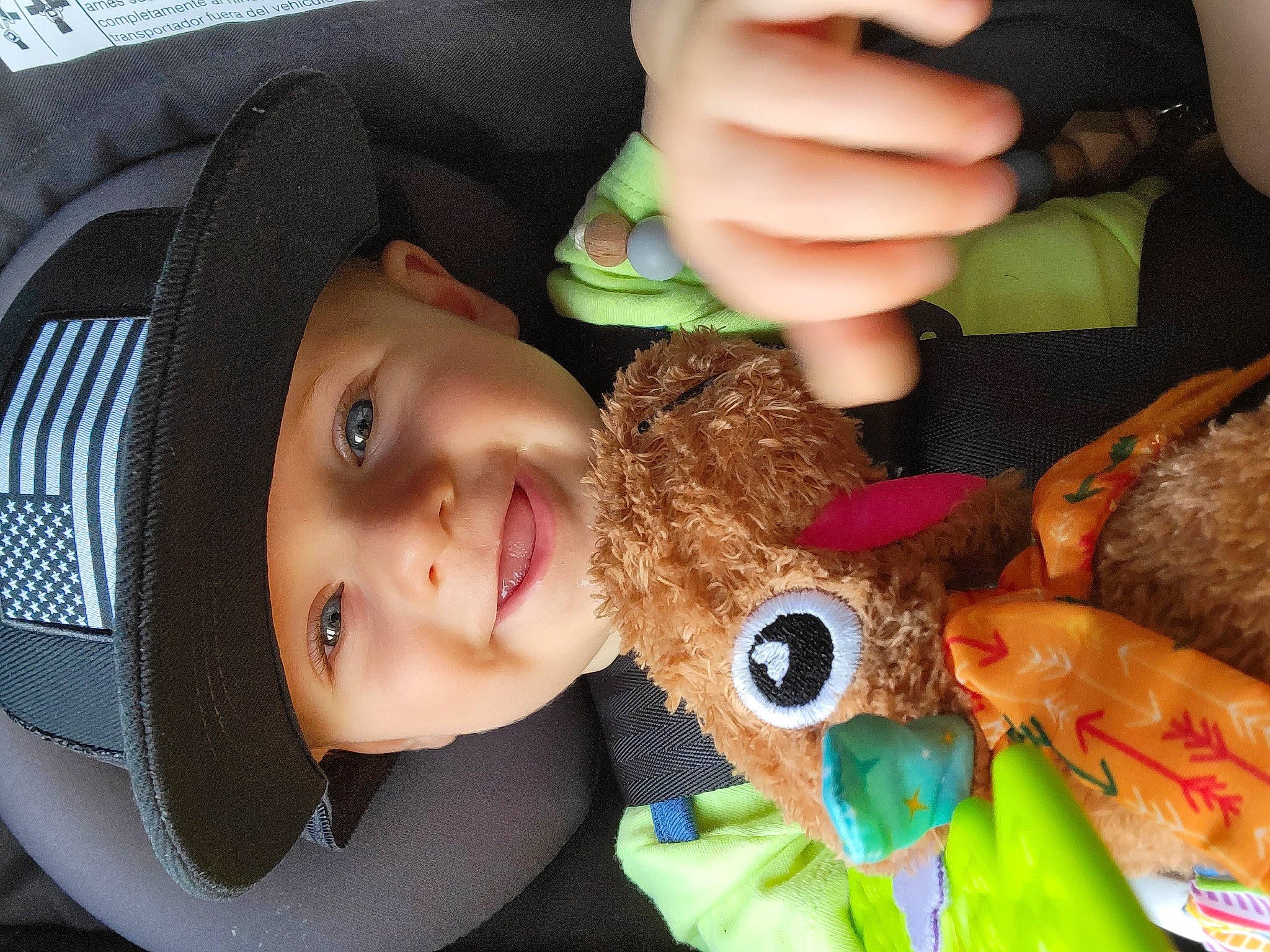 Boaz is registered to the contest to win money with this photo: baby, cap, child, fashion_accessory, fawn, fun, gesture, green, happy, hat, headwear, joy, nail, person, skin, smile, stuffed_toy, thumb, toddler, toy