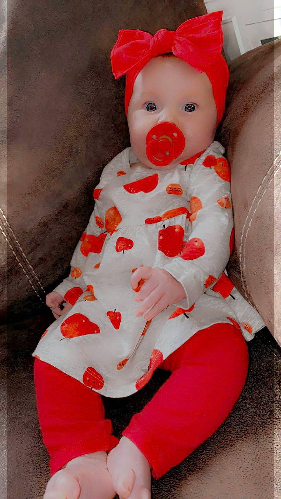 Kaisley Ann joined the competition — help win amazing prizes! baby, baby_products, baby_toddler_clothing, carmine, child, costume, costume_hat, doll, dress, event, hat, one_piece_garment, orange, pattern, peach, person, pink, red, sitting, sleeve