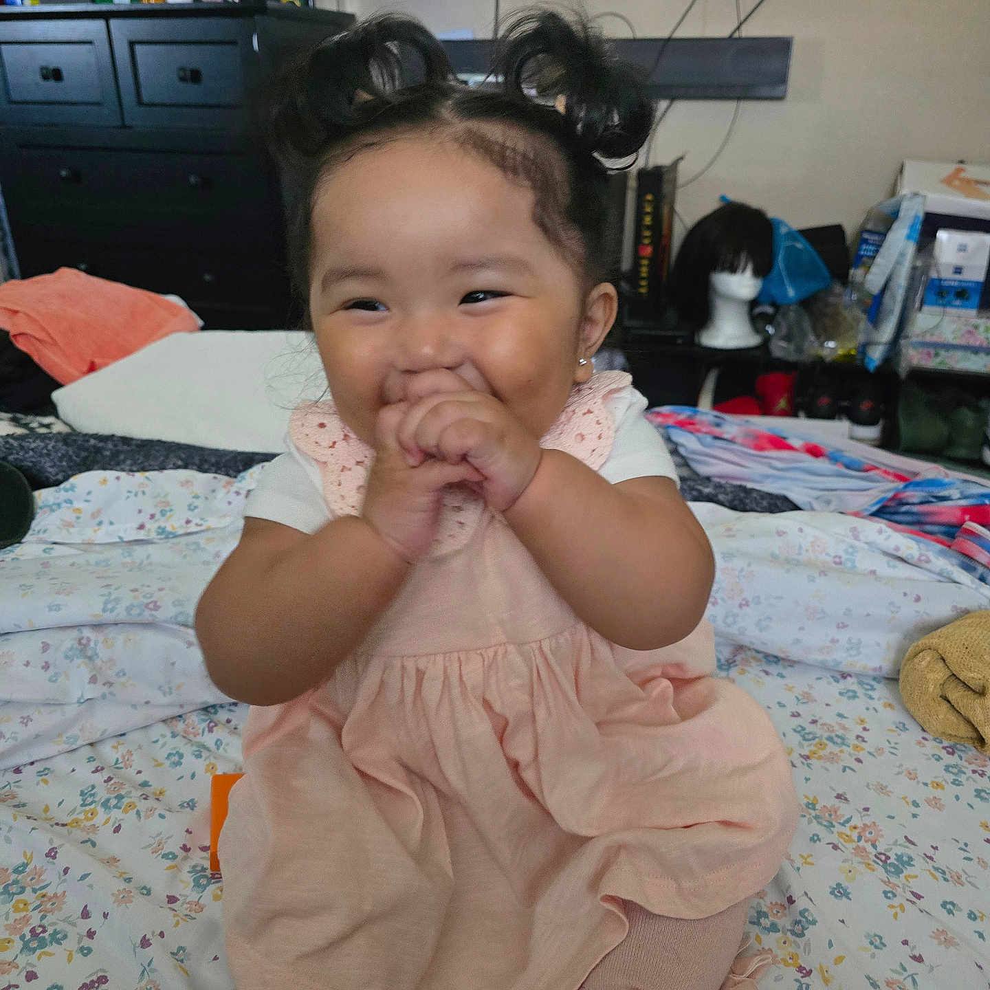 Aria joined the competition — help win amazing prizes! baby, child, girl, smiling, happy, hair_buns, pink_dress, tights, bed, floral_bedspread, indoor, furniture, dresser, television, toys, room, playful, cute, portrait, person