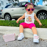 Chloe joined the competition — help win amazing prizes! child, toddler, outdoor, sitting, sunglasses, pink_clothing, pink_shorts, hair_bows, braided_hair, sneakers, handbag, pearl_handle, capybara_shirt, car, suv, grass, curb, house, tree, blue_sky