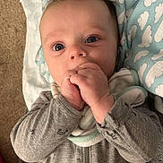 Johnathan is registered to the contest to win money with this photo: baby, bodypart, bonnet, clothing, coat, face, finger, hand, hat, head, hoodie, jacket, knitwear, newborn, pants, person, photography, portrait, sweater, sweatshirt