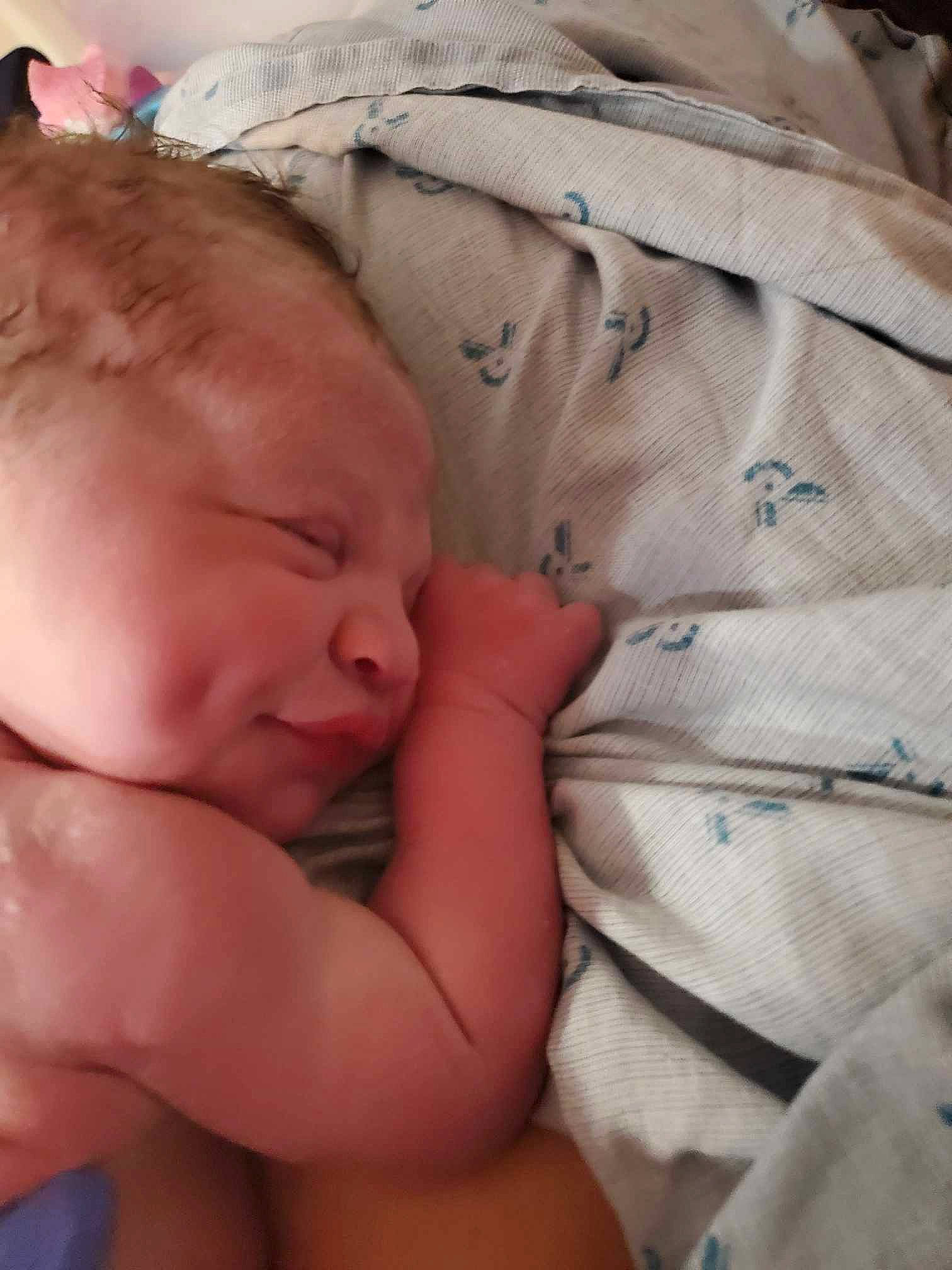 Sawyer is registered to the contest to win money with this photo: baby, baby_toddler_clothing, bed, bedtime, cheek, child, comfort, eyebrow, happy, linens, nap, nose, pattern, person, product, room, skin, sleep, textile, thumb