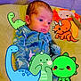 Nathaniel joined the competition — help win amazing prizes! baby, infant, dinosaur_onesie, cartoon_dinosaurs, cute, child, soft_surface, plush_toy, orange_lion_pillow, blue_pajamas, indoor, portrait, smiling_cartoon, colorful, playful, young_child, seated, adorable, expression, cozy