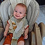 baby, high_chair, smile, bib, clothing, infant, child, cute, indoor, seat, happy, face, person, young_child, orange_shorts, white_shirt, fabric, baby_bib, baby_seat, floor