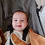 baby, blue_eyes, blanket, clothing, face, happy, infant, person, portrait, stroller, straps, smile, cute, child, baby_clothes, blanket_edge, closeup, seat, baby_boy, comfort