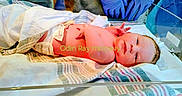 Odin is registered to the contest to win money with this photo: newborn, baby, infant, hospital, medical, delivery_room, warming_bed, blanket, swaddling, gloves, healthcare_worker, birth, portrait, lying_down, face, eyes_open, hospital_bedding, clinical, photography, text_overlay