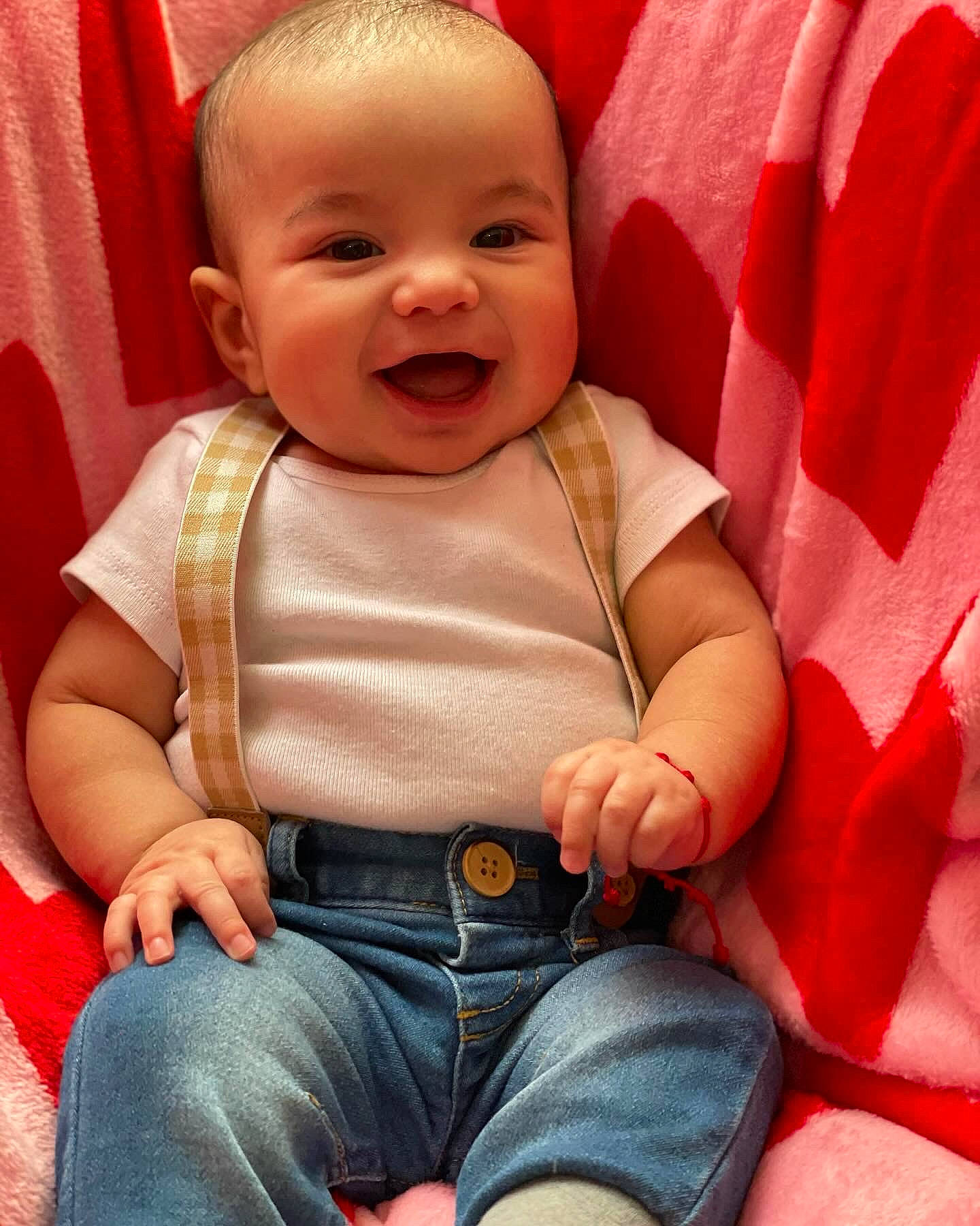 Jaxson is registered to the contest to win money with this photo: arm, baby, baby_toddler_clothing, cheek, chin, comfort, eye, facial_expression, hand, happy, head, human_body, lip, mouth, nose, orange, person, product, skin, sleeve