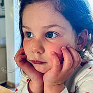 Alba participe au concours pour gagner de l'argent avec cette photo : blue_eyes, casual, child, closeup, cute, daylight, earrings, expression, face, hands, heart_pattern, indoor, long_hair, person, portrait, resting, rosy_cheeks, skin, sweater, thoughtful