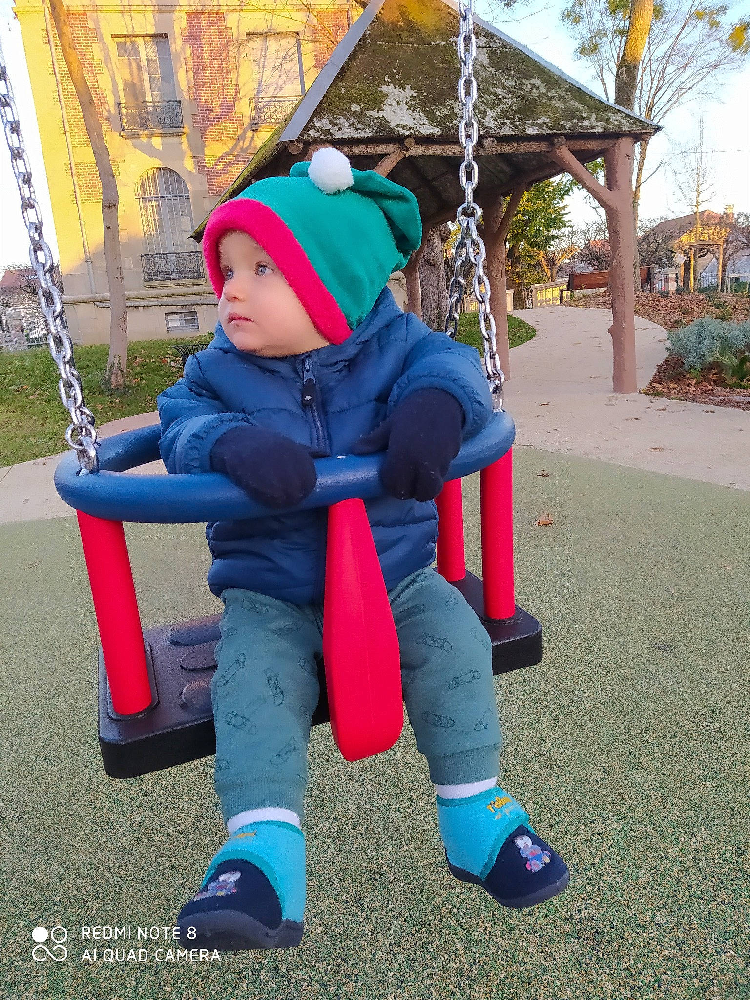 Darius a rejoint le concours — aidez-le/la à gagner de superbes lots ! child, headwear, jeans, outdoor_play_equipment, person, playground, public_space, sitting, swing