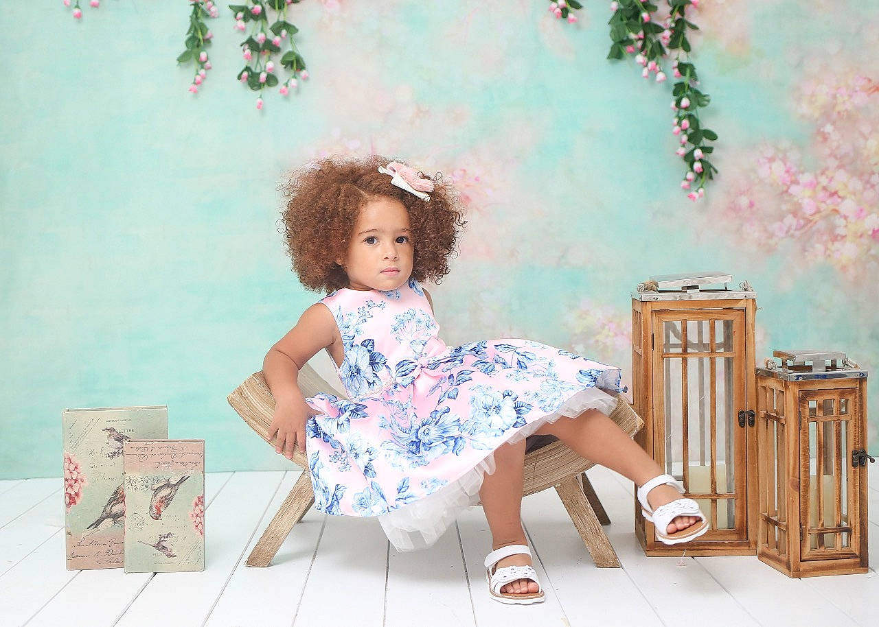 Flor is registered to the contest to win money with this photo: art, brown_hair, chair, child, doll, dress, fashion_design, fawn, happy, illustration, pattern, person, pink, plant, sitting, toy, tree, vintage_clothing, wall, wig