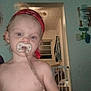 toddler, child, pacifier, red_bandana, shirtless, indoor, baby_gate, window, doorway, household, person, young_child, face, expressionless, blond_hair, toy, room, lighting, curtains, wall