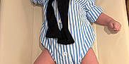 Liam a rejoint le concours — aidez-le/la à gagner de superbes lots ! baby, infant, striped_onesie, blue_shoes, white_socks, cushioned_surface, raised_arm, black_sweater, comfortable, cute, lying_down, indoor, small_person, child, footwear, casual_clothing, smiling, portrait, human, adorable