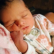 Serenity is registered to the contest to win money with this photo: baby, sleeping, infant, onesie, blanket, hand, face, closed_eyes, peaceful, cozy, soft, pastel, newborn, cute, portrait, child, human, skin, fingers, resting