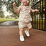 toddler, child, park, bridge, walking, outdoor, trees, metal_railing, shoes, clothing, path, grass, daylight, person, young_child, cute, summer, playful, nature, sidewalk
