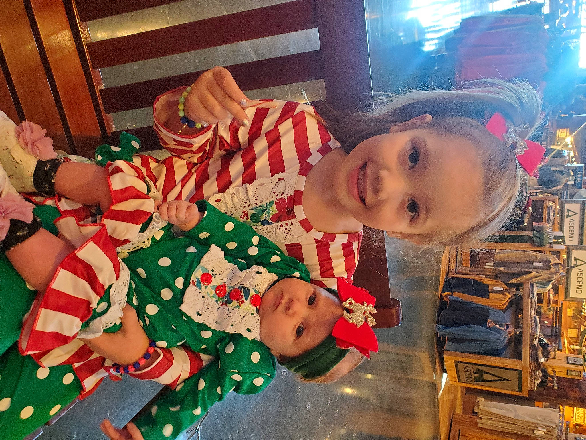 Aaliyah joined the competition — help win amazing prizes! baby, baby_toddler_clothing, carmine, child, christmas, christmas_eve, event, fun, happy, hat, headwear, holiday, joy, lap, pattern, person, room, sleeve, smile, sock