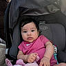 baby, car_seat, child, clothing, comfort, cute, face, graco, hand, head, indoor, infant, person, pink_onesie, plush_toy, portrait, seat, sitting, toy, young_child