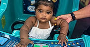Wesley is registered to the contest to win money with this photo: accessories, baby, bodypart, bracelet, face, finger, hand, head, indoors, jewelry, necklace, outdoorplayarea, outdoors, person, photography, playarea, portrait, slide, toy, urban