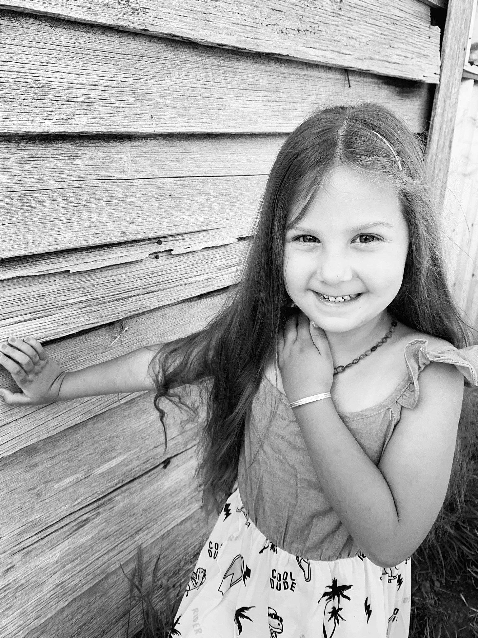 Starla is registered to the contest to win money with this photo: black, black_and_white, eye, face, flash_photography, fun, gesture, grass, hair, happy, head, joy, people_in_nature, person, plant, skin, smile, standing, style, tree