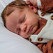Léo participe au concours pour gagner de l'argent avec cette photo : baby, brown, button, child, closeup, clothing, cute, face, hand, head, infant, newborn, peaceful, portrait, relax, rest, skin, sleeping, soft, white