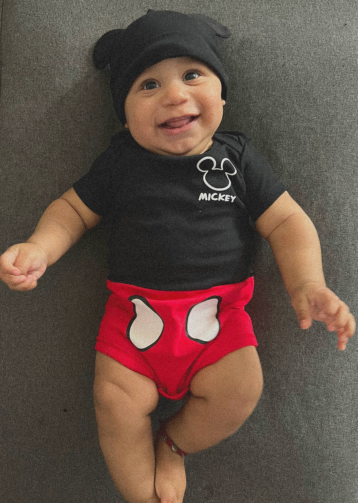 Amari is registered to the contest to win money with this photo: baby_toddler_clothing, cool, eye, face, head, headgear, headwear, human_body, joy, knee, leg, neck, one_piece_swimsuit, outerwear, person, shoulder, sleeve, smile, sportswear, stomach