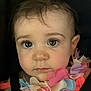 baby, child, face, eyes, nose, flower_necklace, pink_clothing, closeup, portrait, infant, cute, expression, skin, hair, young_child, person, soft_lighting, indoors, head_and_shoulders, seatbelt