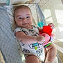 Royce is registered to the contest to win money with this photo: baby, infant, toy, stuffed_animal, onesie, blanket, crib, mesh, pacifier, smiling, cute, child, indoor, playful, happy, soft_toys, sunlight, foot, hand, person