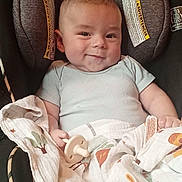 Royce joined the competition — help win amazing prizes! baby, infant, car_seat, blanket, pacifier, smiling, child, cute, face, clothing, comfort, seat, warning_label, pattern, fabric, indoors, young_child, portrait, holding, resting