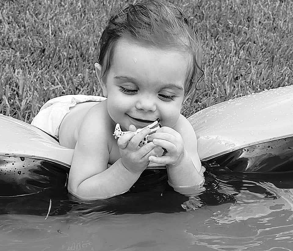 Aubriella is registered to the contest to win money with this photo: arm, black_and_white, child, eye, facial_expression, finger, flash_photography, fun, gesture, grass, hairstyle, hand, happy, head, human_body, people_in_nature, person, smile, style, toddler