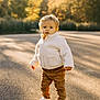toddler, child, outdoor, autumn, sunlight, path, jacket, pants, white_shoes, standing, shadow, nature, trees, daylight, cute, portrait, young_child, casual_clothing, seasonal, curious
