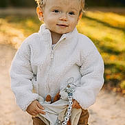 Sandro participe au concours pour gagner de l'argent avec cette photo : toddler, child, outdoor, autumn, sunlight, fleece_jacket, toy, pacifier_clip, warm_clothing, path, nature, portrait, happy, cute, blond_hair, young_child, smiling, person, daylight, warm_light