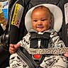 Zade joined the competition — help win amazing prizes! baby, car_seat, child, infant, onesie, animal_print, smile, straps, indoor, window, black, white_clothing, seat, cute, hand, face, person, happy, childcare, babywearing