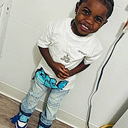 Jimmie joined the competition — help win amazing prizes! child, boy, smiling, white_tshirt, jeans, sneakers, indoor, wooden_floor, necklace, happy, standing, casual, fashion, accessory, candid, portrait, person, young, wall, floor