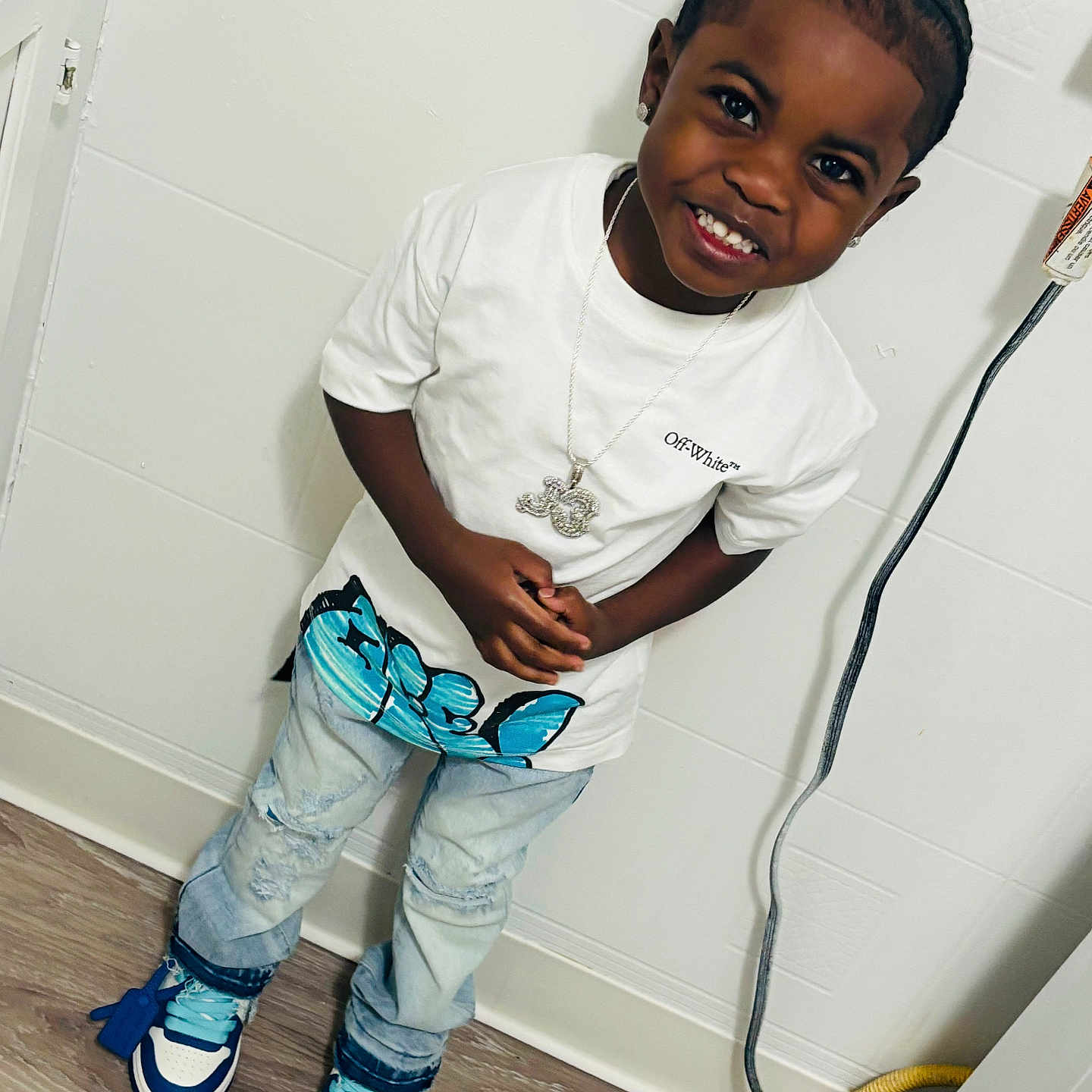 Jimmie joined the competition — help win amazing prizes! accessory, boy, candid, casual, child, fashion, floor, happy, indoor, jeans, necklace, person, portrait, smiling, sneakers, standing, wall, white_tshirt, wooden_floor, young