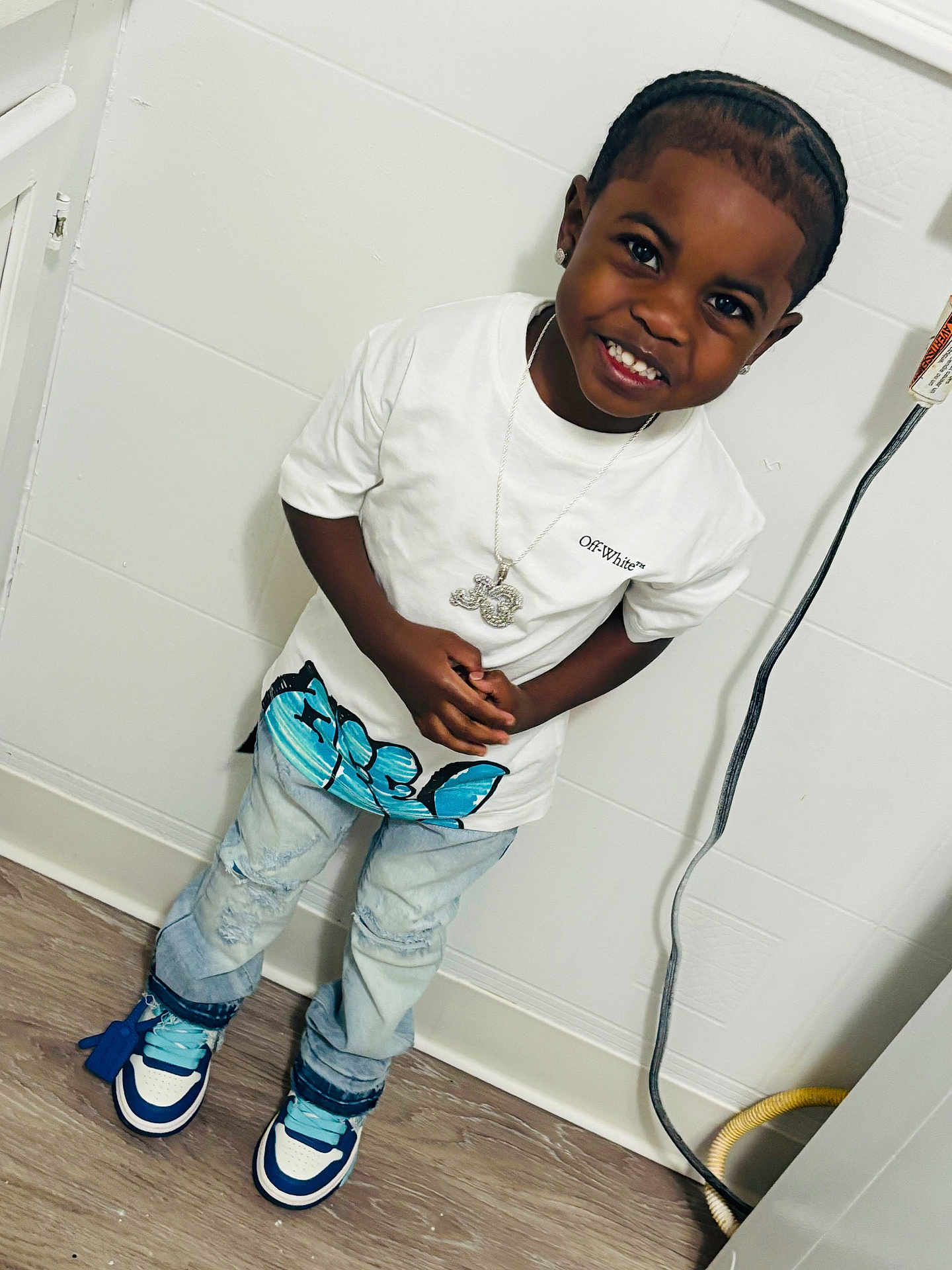 Jimmie joined the competition — help win amazing prizes! child, boy, smiling, white_tshirt, jeans, sneakers, indoor, wooden_floor, necklace, happy, standing, casual, fashion, accessory, candid, portrait, person, young, wall, floor