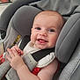 baby, bright_eyes, car_seat, child, clothing, cute, expression, face, gray, hand, happy, indoors, infant, pacifier, red_shirt, safety, seatbelt, skin, smile, young