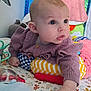 baby, child, clothing, colorful, curious, cute, drool, face, indoor, infant, lying_down, patterned, play_mat, portrait, purple, small_hand, soft_toys, sweater, toys, wide_eyes