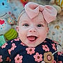 accessory, apparel, baby, background, bow, cheerful, child, closeup, clothing, cute, face, flower_pattern, happy, headband, indoors, infant, plush, portrait, smiling, toy