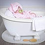 baby, bathtub, cucumber_slices, pink_towel, towel_turban, bath_brush, white_towel, relaxation, spa, clawfoot_tub, flooring, baby_care, indoor, child, resting, cute, skin_care, funny, headwear, person