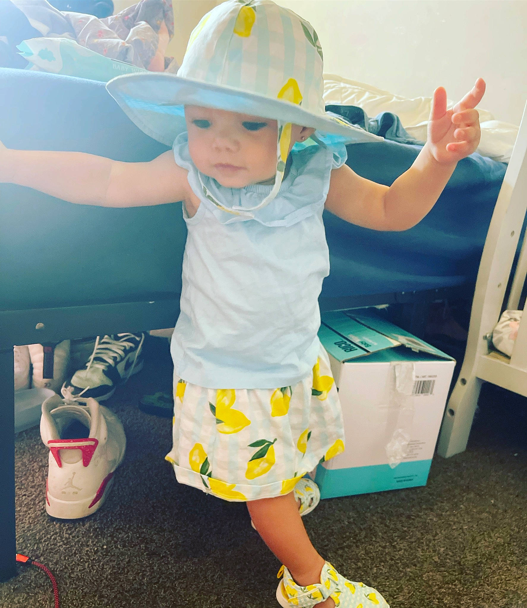 Luna is registered to the contest to win money with this photo: baby, baby_toddler_clothing, child, electric_blue, fashion_accessory, fun, happy, hard_hat, headwear, helmet, human_leg, leisure, pattern, person, personal_protective_equipment, play, sandal, shorts, sleeve, t_shirt