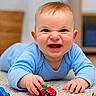 Shaytan is registered to the contest to win money with this photo: baby, child, blue_onesie, carpet, toy_car, toy_vehicle, crawling, smiling, happy, indoor, floor, face, head, hands, play, cute, infant, person, room, expression