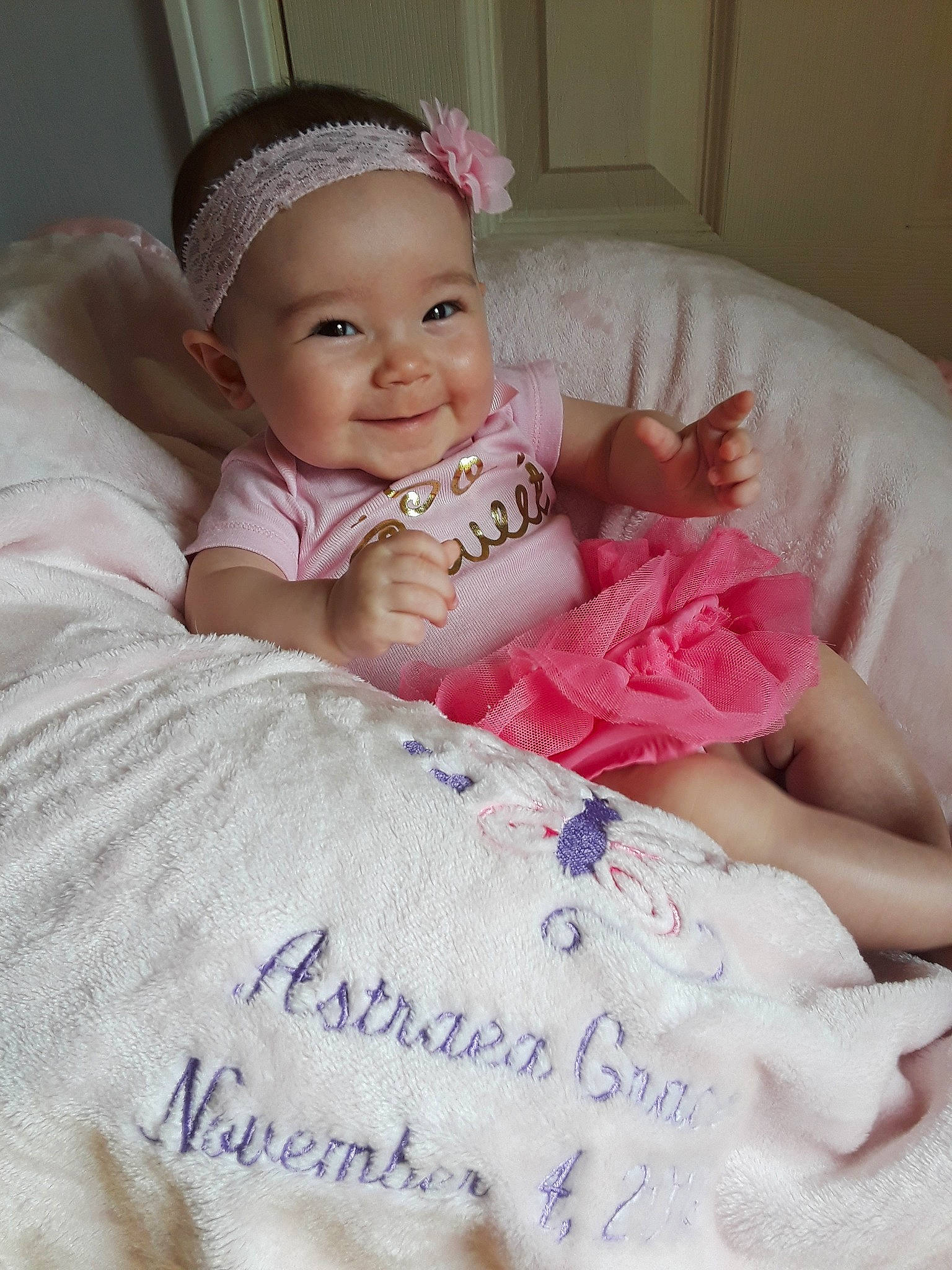 Astraea is registered to the contest to win money with this photo: baby, baby_products, baby_toddler_clothing, cheek, child, finger, hair_accessory, headband, headgear, headpiece, joy, person, pink, product, skin, smile, toddler
