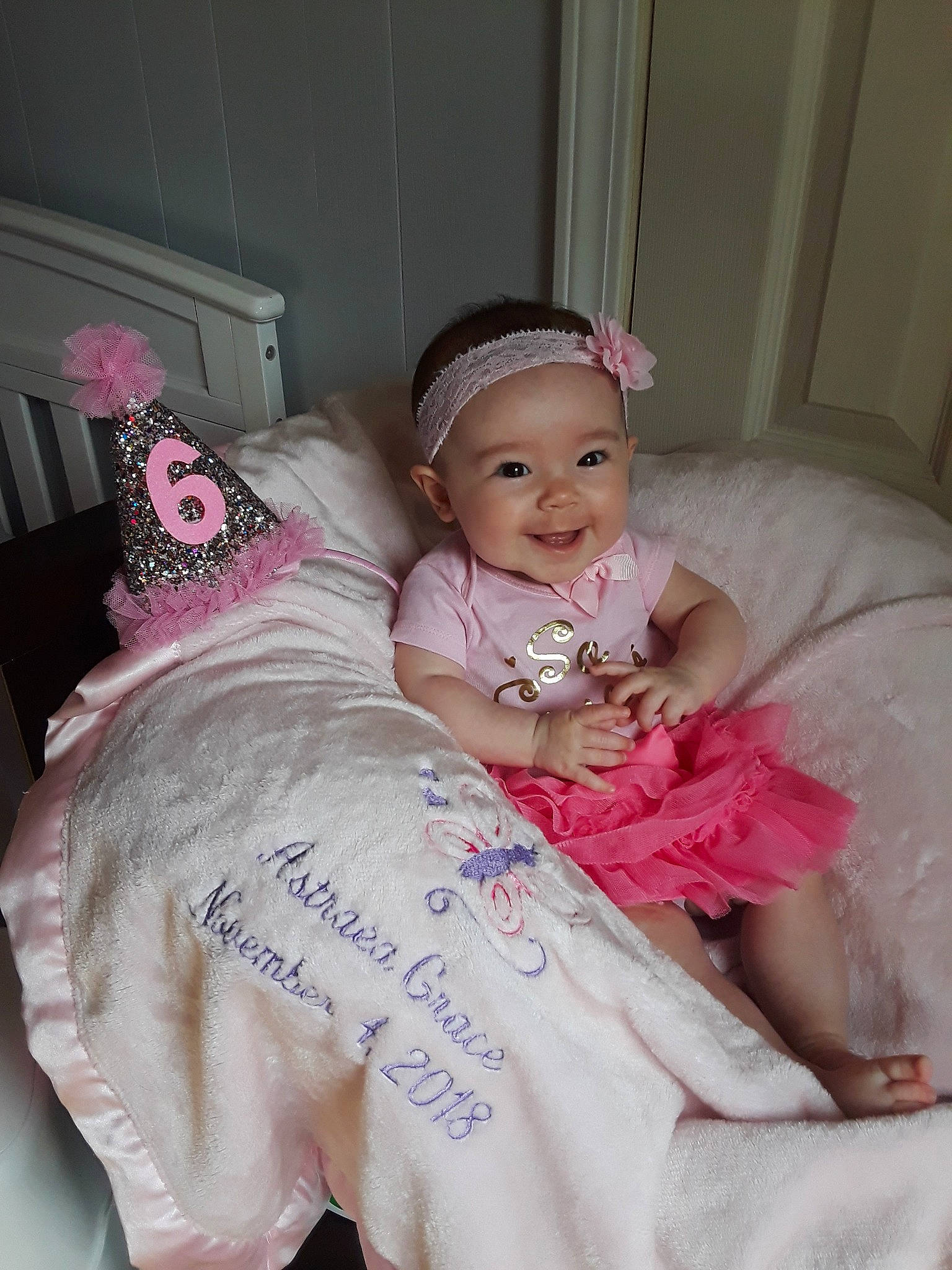 Astraea is registered to the contest to win money with this photo: baby, baby_products, baby_toddler_clothing, cheek, child, hair_accessory, joy, person, pink, skin, smile, toddler