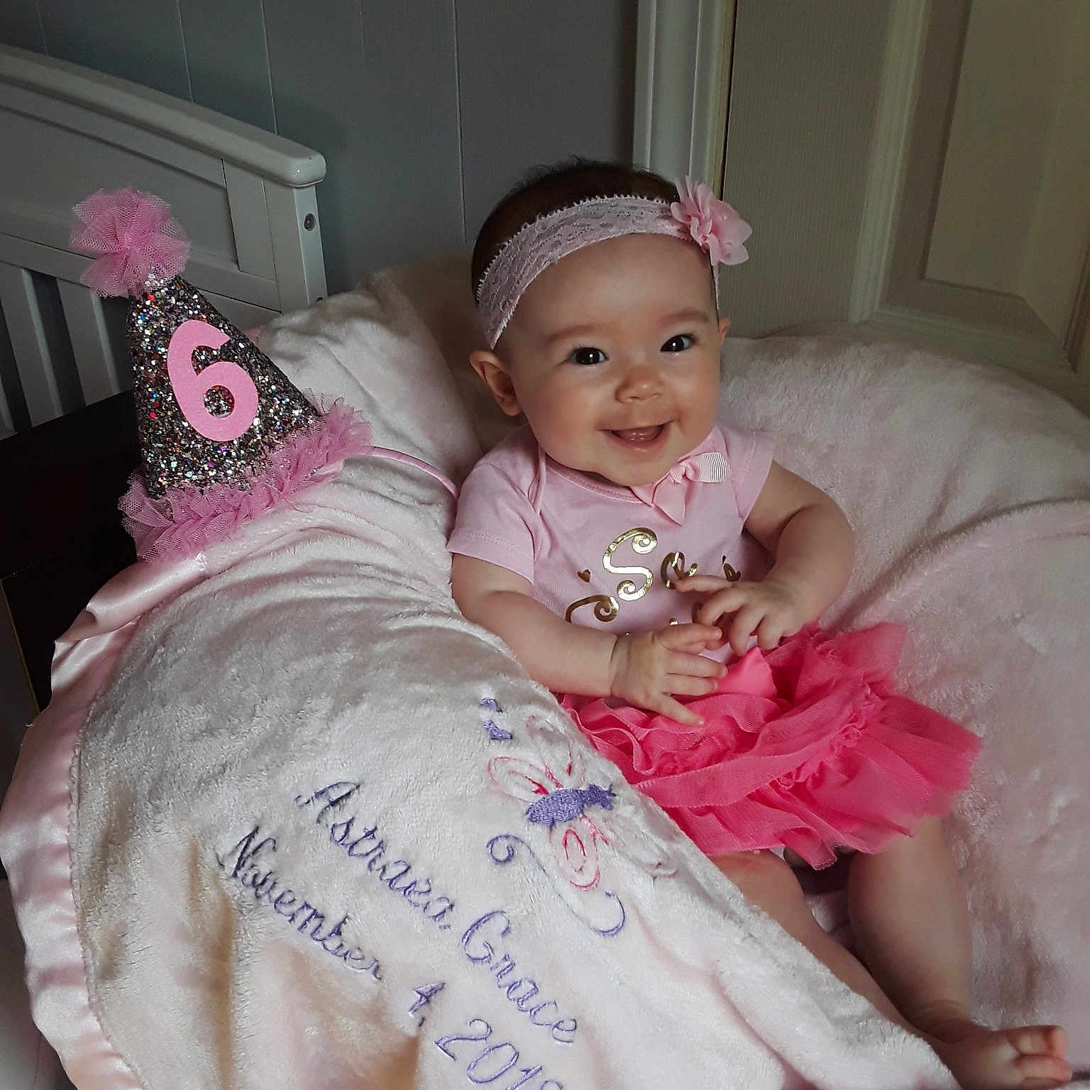 Astraea is registered to the contest to win money with this photo: baby, baby_products, baby_toddler_clothing, cheek, child, hair_accessory, joy, person, pink, skin, smile, toddler