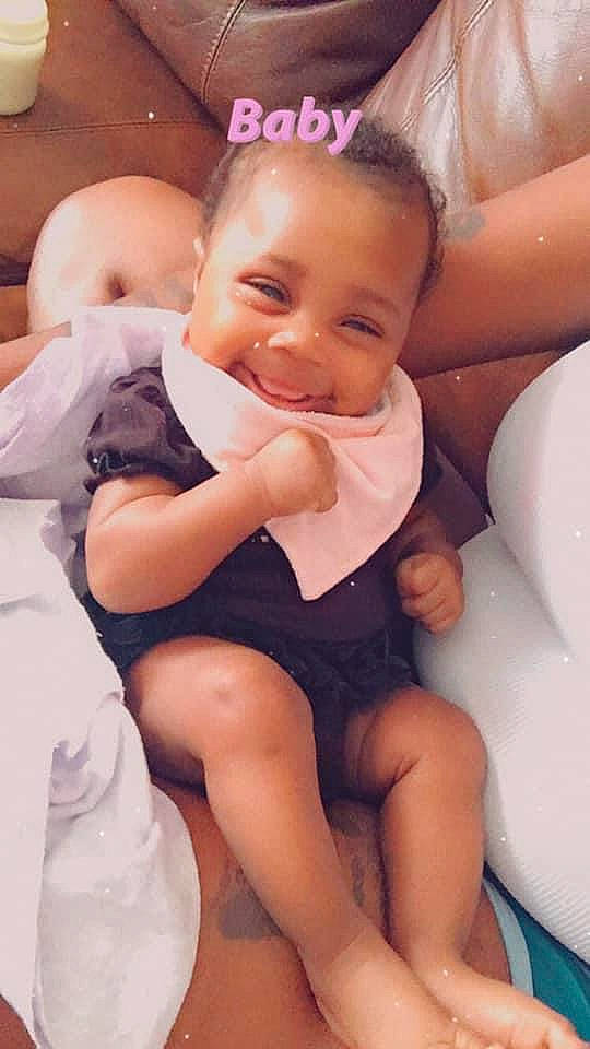 Londynn is registered to the contest to win money with this photo: baby_toddler_clothing, comfort, dress, facial_expression, finger, gesture, hair, happy, human_body, joint, joy, leg, mammal, muscle, person, pink, shoulder, skin, smile, thigh