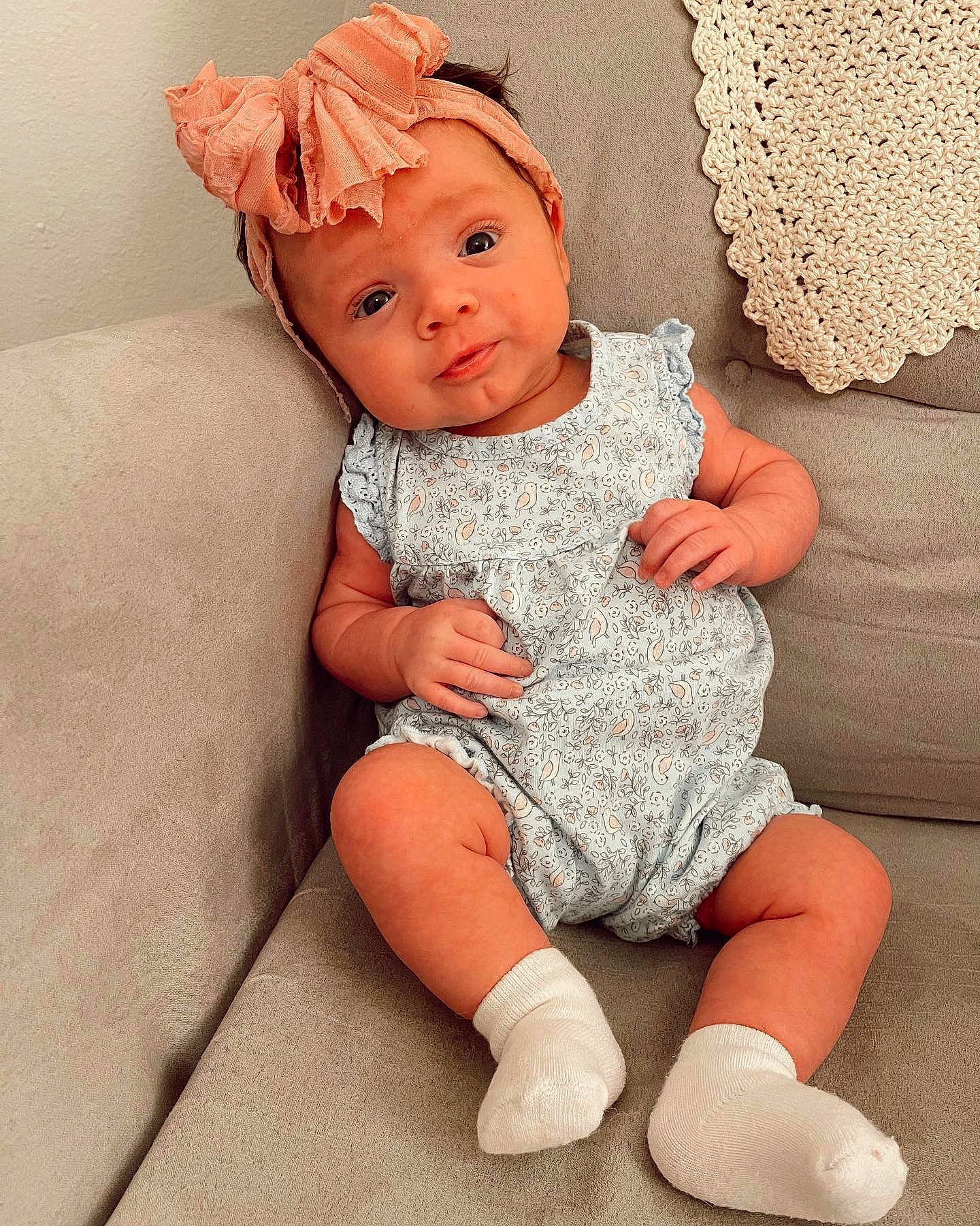 Madelynn is registered to the contest to win money with this photo: baby, baby_toddler_clothing, cheek, child, comfort, costume_hat, dress, eye, face, finger, head, headwear, human_body, human_leg, iris, lip, pattern, person, pink, skin