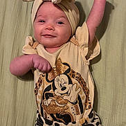 Liyana joined the competition — help win amazing prizes! baby, child, headband, bow, smile, minnie_mouse, cartoon, clothing, patterned_pants, animal_print, cute, infant, lying_down, raised_arm, happy, face, person, soft_surface, apparel, fashion